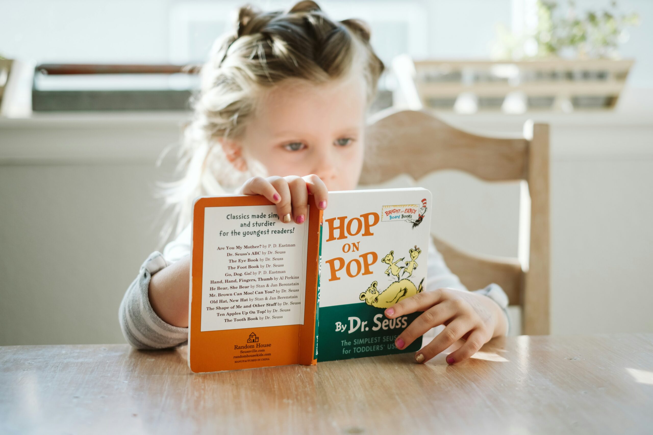 A girl reading book to learn English Language
